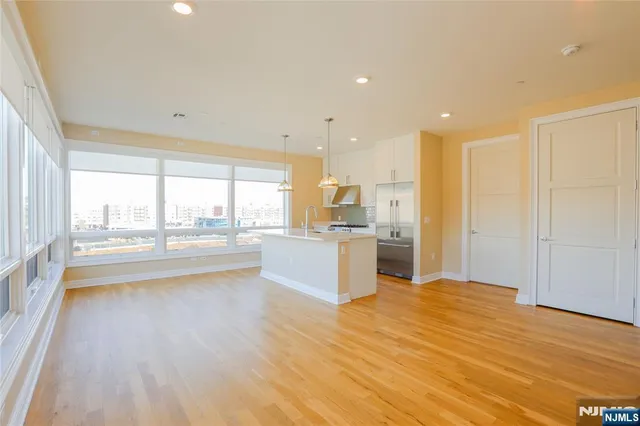 a large kitchen with a large counter top appliances and cabinets
