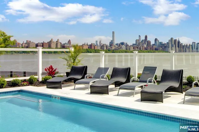 a terrace with outdoor seating and a lake view