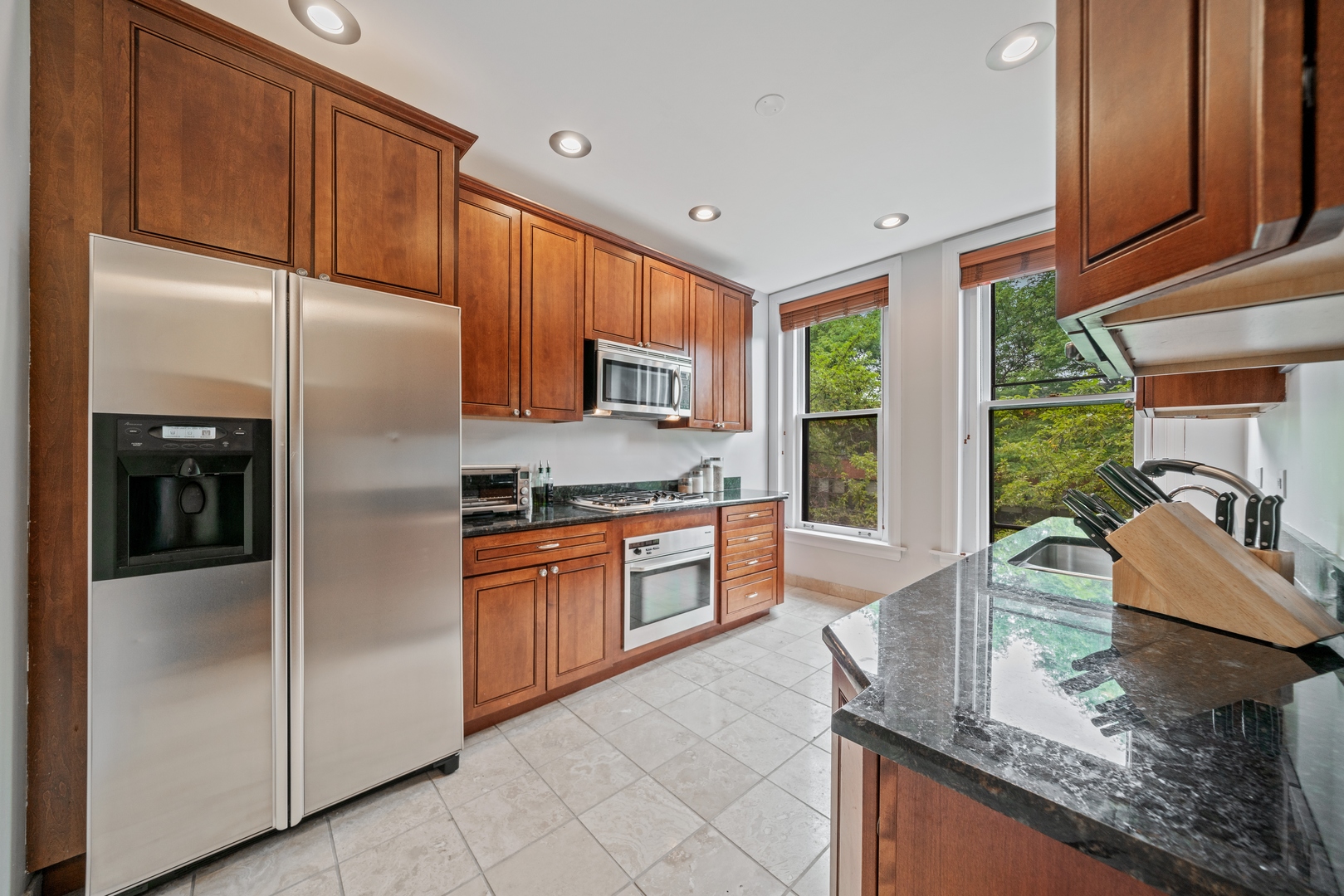 1125 West Belden Avenue, Unit 2 Chicago, IL 60614 - Photo 7 of 10 a kitchen with stainless steel appliances granite countertop a refrigerator and a sink