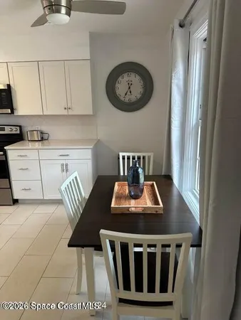a kitchen with a stove a dining table and chairs