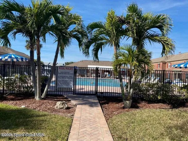 a front view of a building with a yard