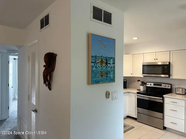 a kitchen with stainless steel appliances and white cabinets