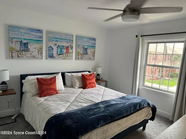 a bedroom with a large bed and a window