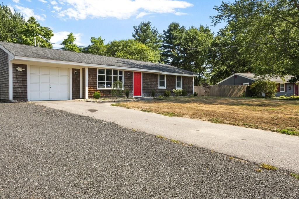 a front view of a house with a space and trees