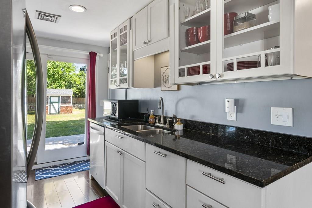 266 Bushee Road Swansea, MA 02777 - Photo 3 of 33 a kitchen with stainless steel appliances granite countertop a sink stove and cabinets