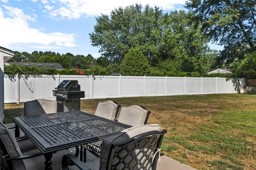 266 Bushee Road Swansea, MA 02777 - Photo 33 of 33 a view of a patio with table and chairs with wooden floor and fence