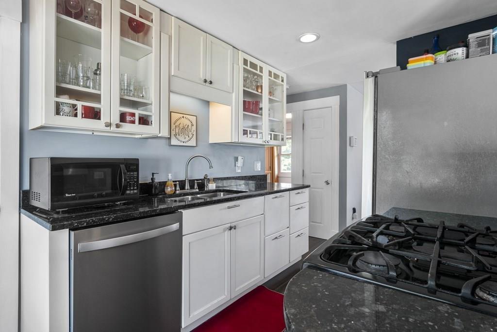 266 Bushee Road Swansea, MA 02777 - Photo 5 of 33 a kitchen with stainless steel appliances a stove a sink and a microwave