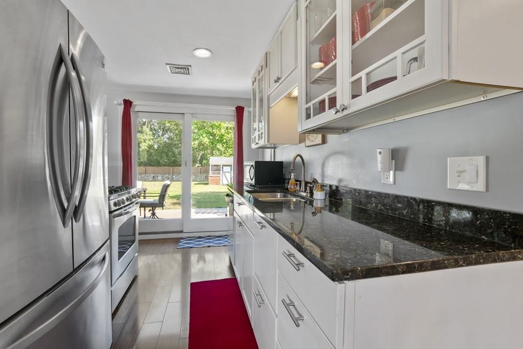 266 Bushee Road Swansea, MA 02777 - Photo 6 of 33 a large white kitchen with a large window and refrigerator
