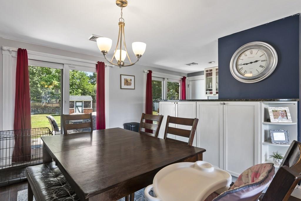 266 Bushee Road Swansea, MA 02777 - Photo 8 of 33 a view of a dining room with furniture a large window clock and a chandelier