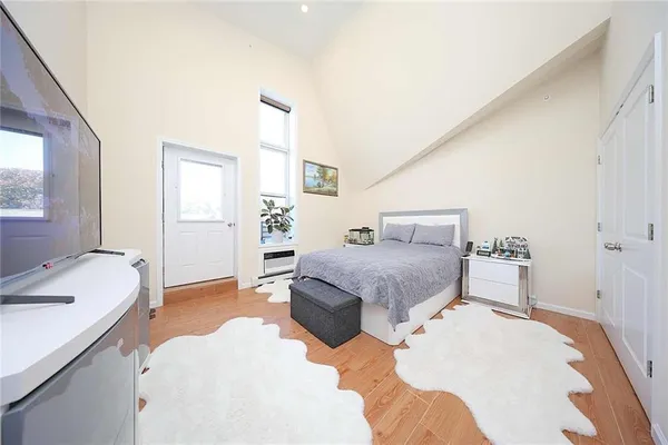 a bedroom with a bed and a couch