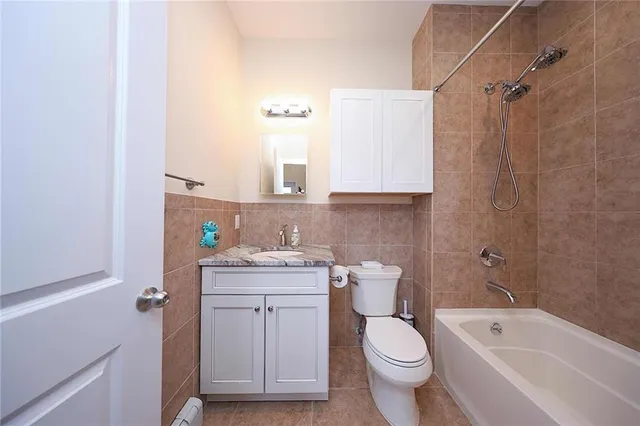 a bathroom with a granite countertop toilet a sink and bathtub