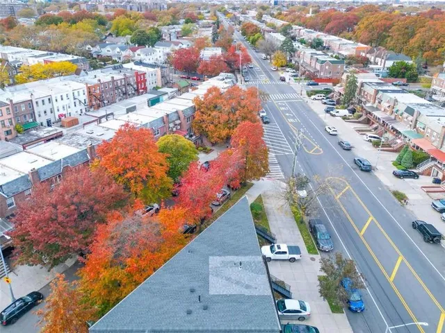 an aerial view of residential house with outdoor space and parking