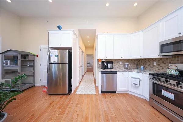 a kitchen with stainless steel appliances a refrigerator sink and stove