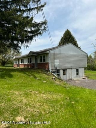 984 Sheehan Road Mehoopany, PA 18629 - Photo 17 of 17 a front view of a house with a yard table and chairs