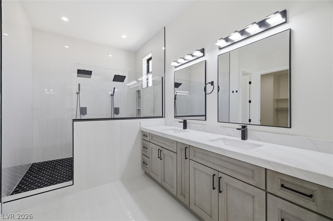 5910 East Kellogg Road Pahrump, NV 89061 - Photo 33 of 58 A sleek bathroom showcasing a spacious walk-in shower and a double vanity with modern fixtures.