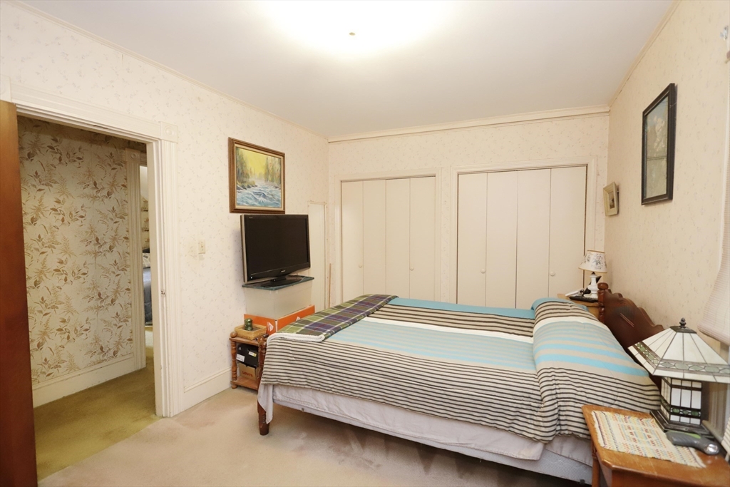 5 Anthony Street Acushnet, MA 02743 - Photo 25 of 37 a bedroom with a bed and a flat screen tv