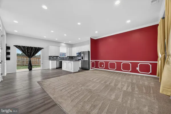 a kitchen with granite countertop white cabinets white stainless steel appliances and a sink