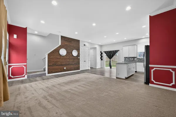 a kitchen with stainless steel appliances granite countertop a sink stove microwave and refrigerator