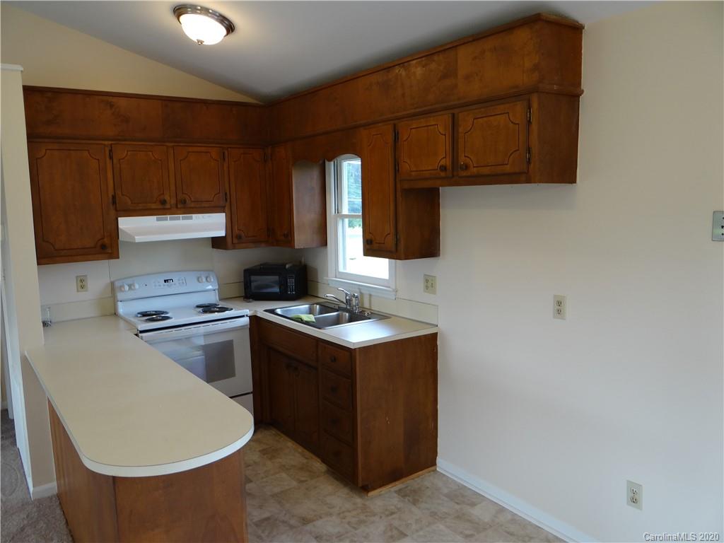 4315 Catawba Burris Road Denver, NC 28037 - Photo 7 of 20 a kitchen with a stove and a microwave