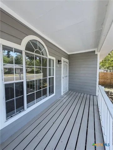 a view of a balcony with wooden floor