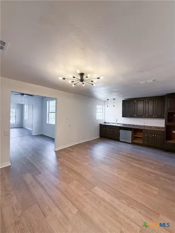 a view of a kitchen with a sink and a stove top oven