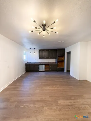 a view of room with cabinet and ceiling fan