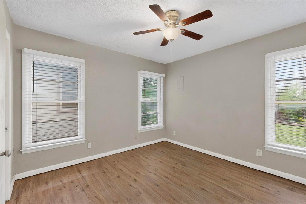 4508 Rutland Avenue Fort Worth, TX 76133 - Photo 28 of 36 a view of an empty room with wooden floor and a window