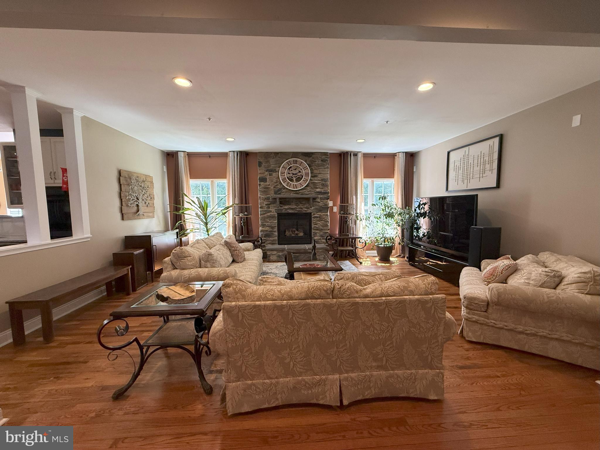 3919 Woodreed Drive Brandywine, MD 20613 - Photo 12 of 88 a living room with furniture a flat screen tv and a fireplace