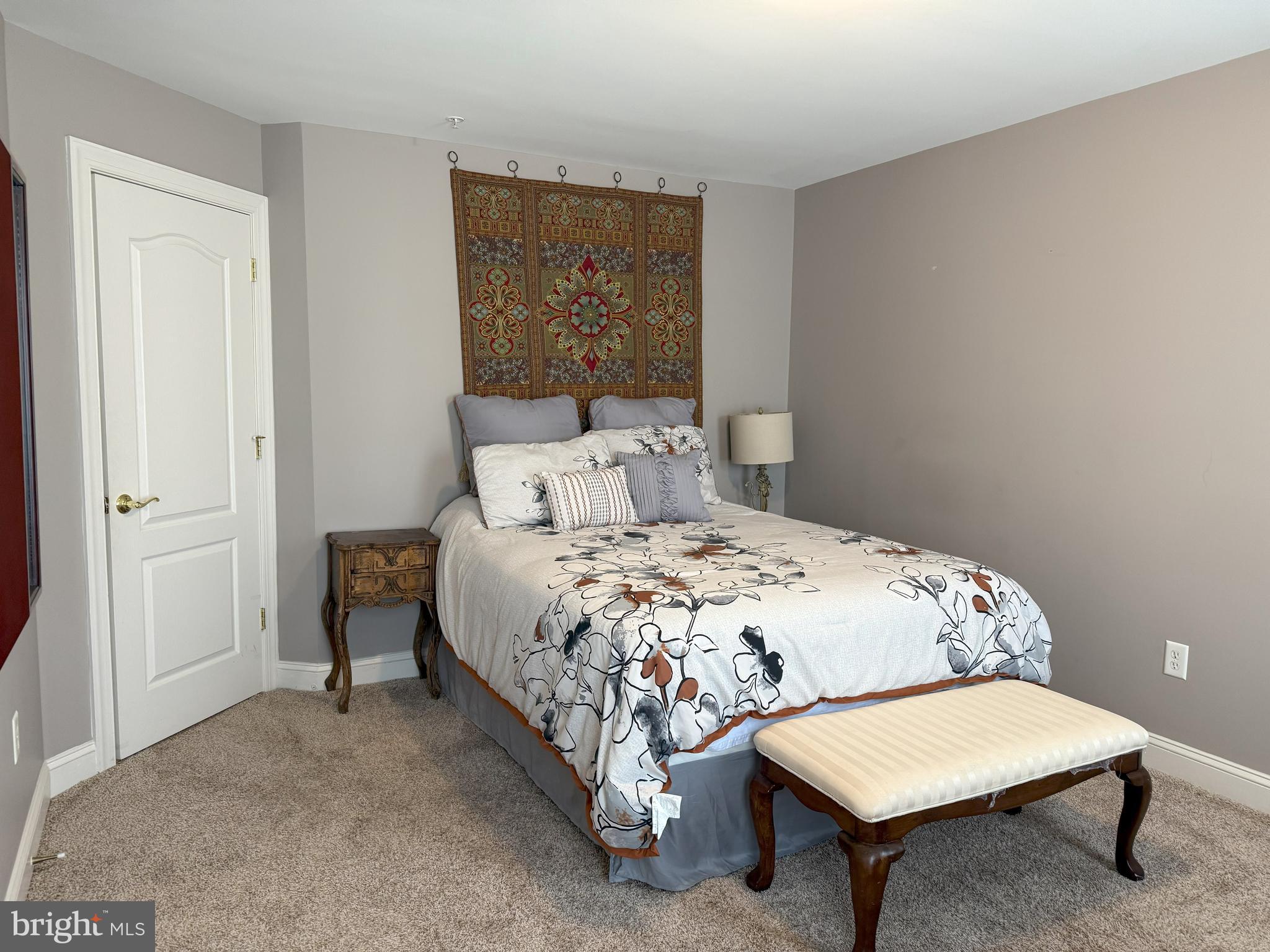 3919 Woodreed Drive Brandywine, MD 20613 - Photo 28 of 88 a bedroom with a bed a chair and potted plant on a stool