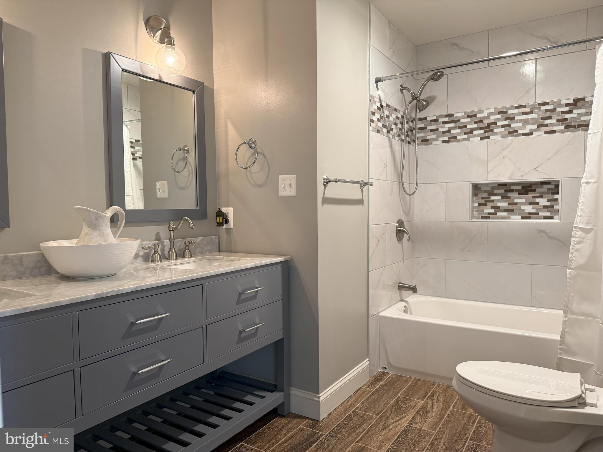 3919 Woodreed Drive Brandywine, MD 20613 - Photo 31 of 88 a bathroom with a granite countertop toilet a sink and bathtub