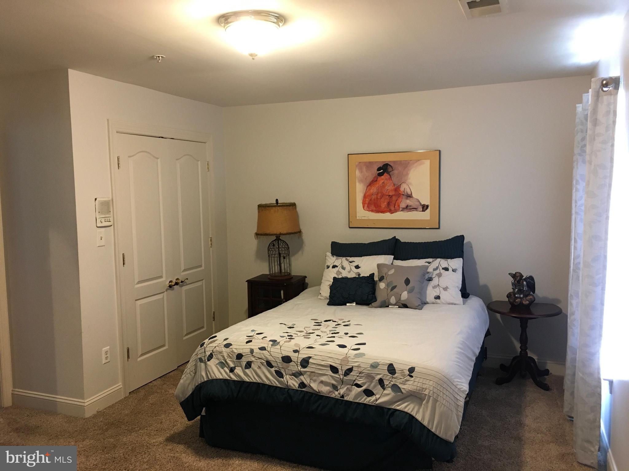 3919 Woodreed Drive Brandywine, MD 20613 - Photo 34 of 88 a bedroom with a bed and a painting on the wall