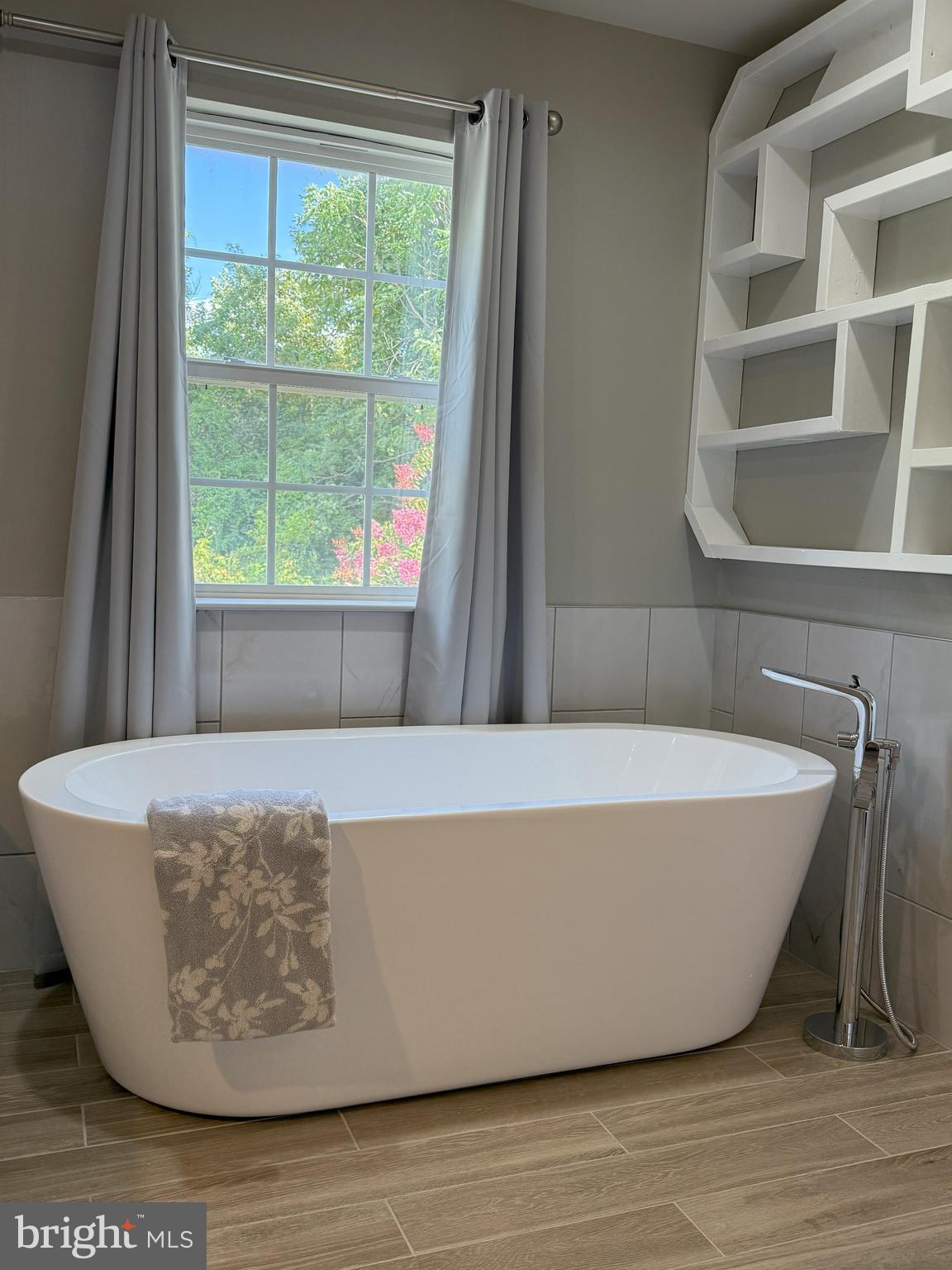 3919 Woodreed Drive Brandywine, MD 20613 - Photo 49 of 88 a white bath tub sitting in a bathroom next to a window