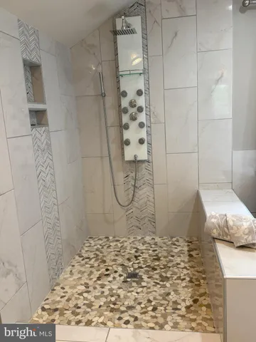 a wooden bench sitting in the middle of a yard