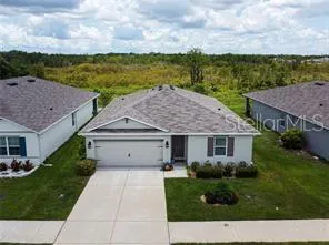 a aerial view of a house with a yard