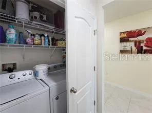 a view of storage and utility room with washer and dryer