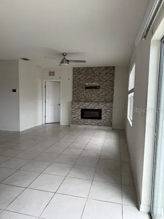 a view of an empty room with a fireplace
