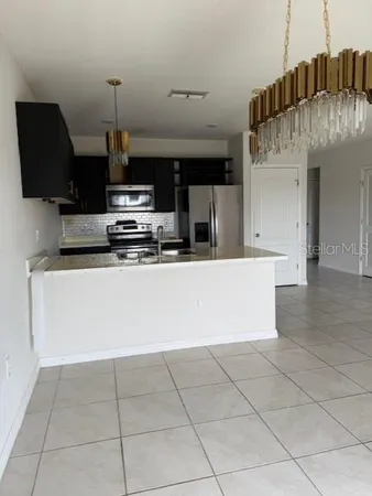 a kitchen with stainless steel appliances a sink a stove a microwave and cabinets