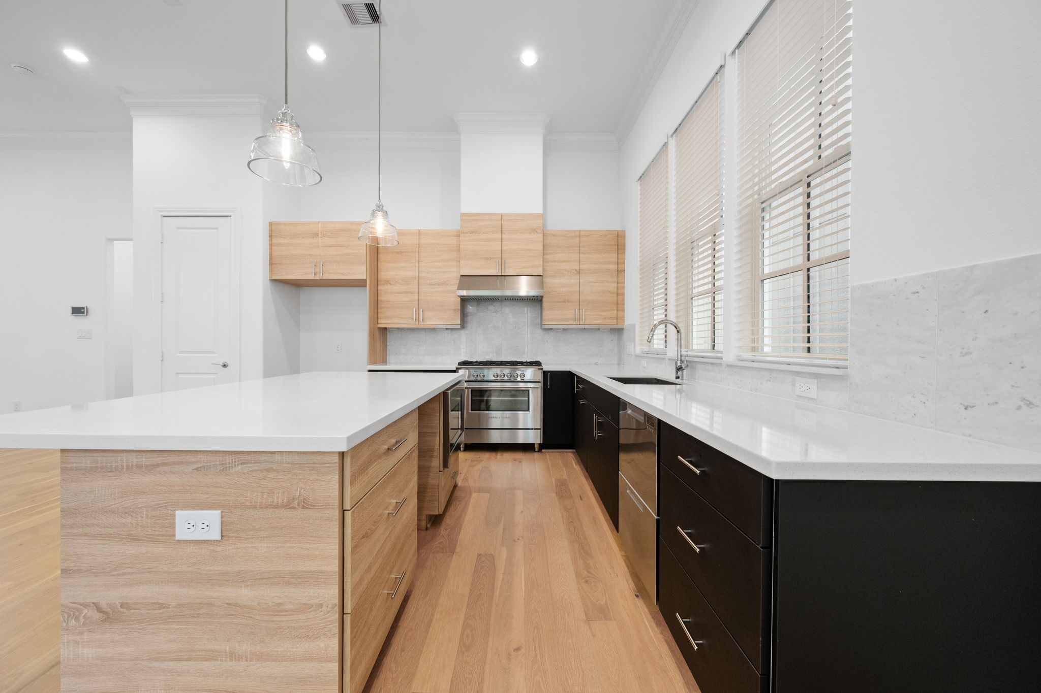 614 Delmar Street Houston, TX 77023 - Photo 12 of 36 a kitchen with kitchen island a sink stove and wooden cabinets