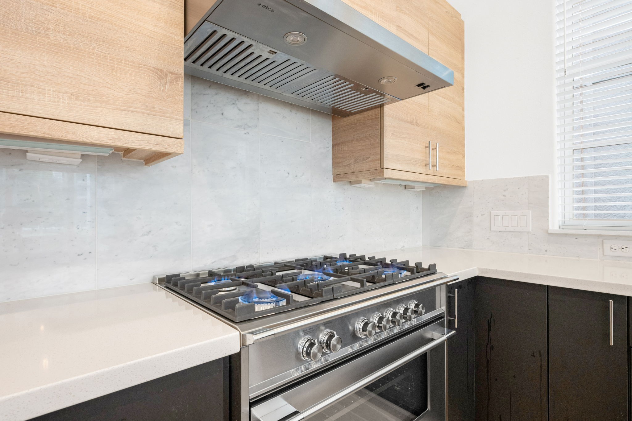 614 Delmar Street Houston, TX 77023 - Photo 17 of 36 a kitchen with stainless steel appliances granite countertop a stove and a microwave
