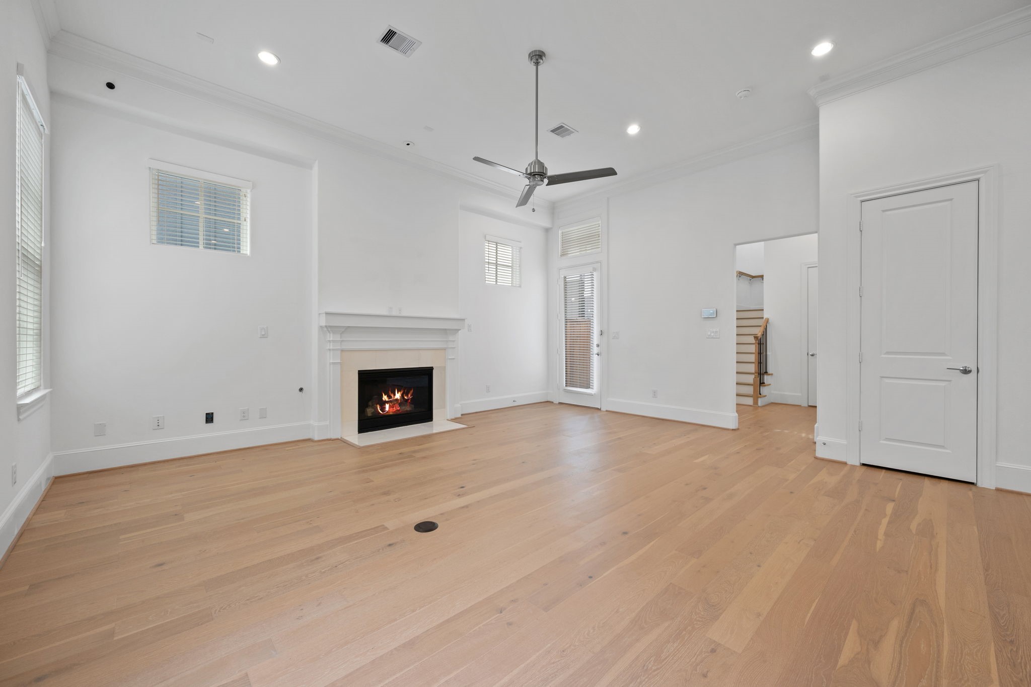 614 Delmar Street Houston, TX 77023 - Photo 6 of 36 a view of an empty room with a fireplace and a window
