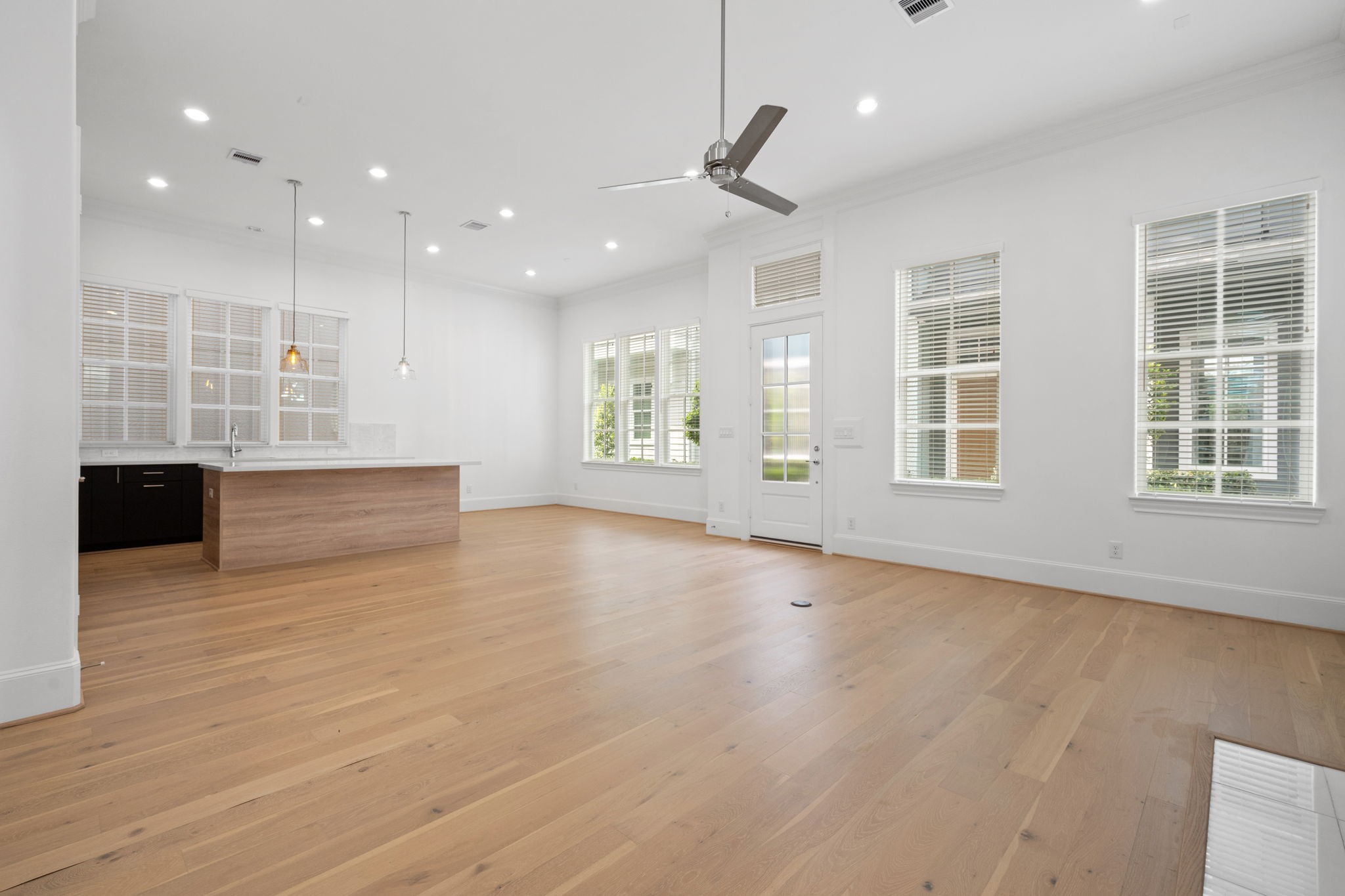 614 Delmar Street Houston, TX 77023 - Photo 8 of 36 an empty room with wooden floor and windows