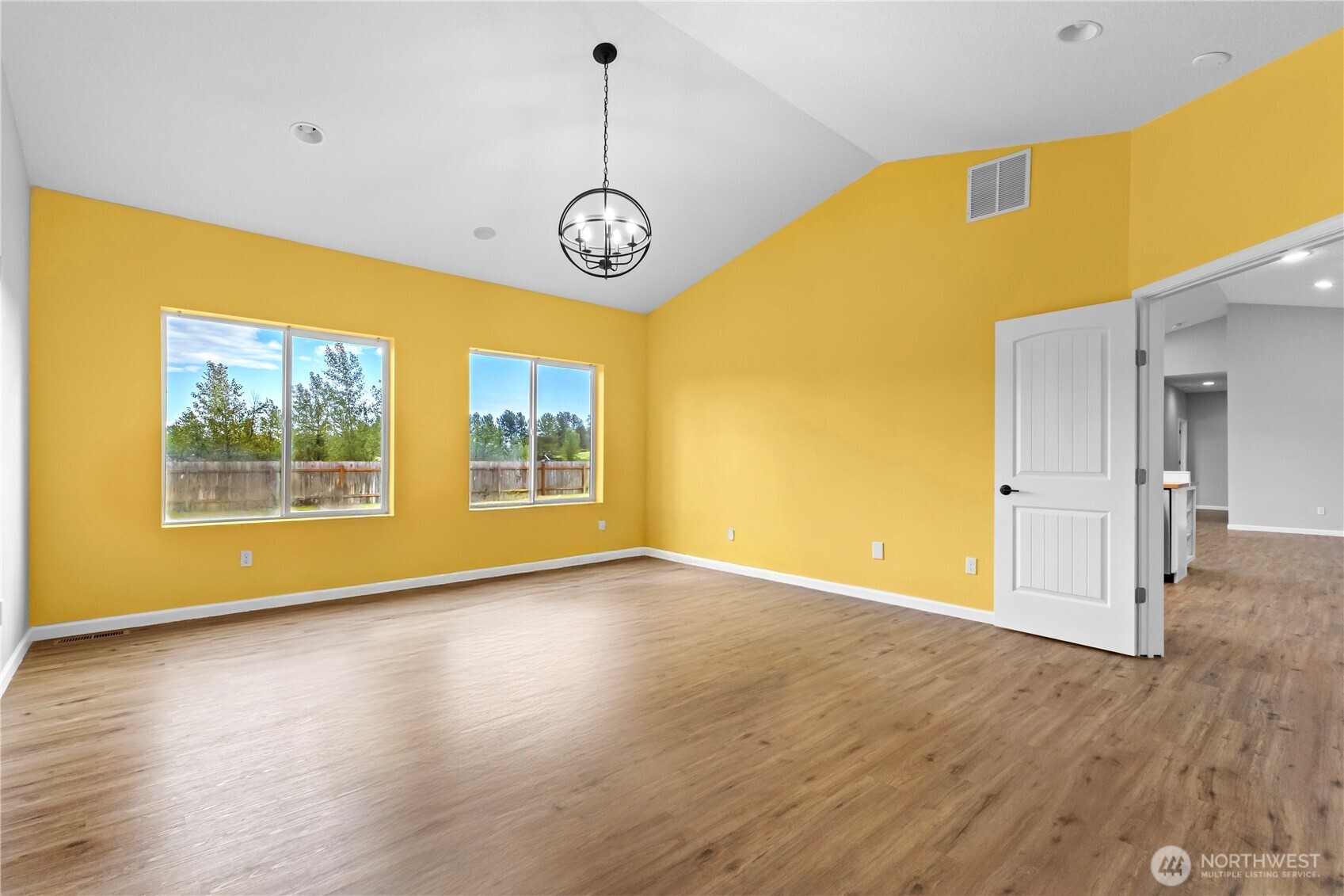 249 Flatt Road Kelso, WA 98626 - Photo 17 of 39 a view of an empty room with wooden floor and a window