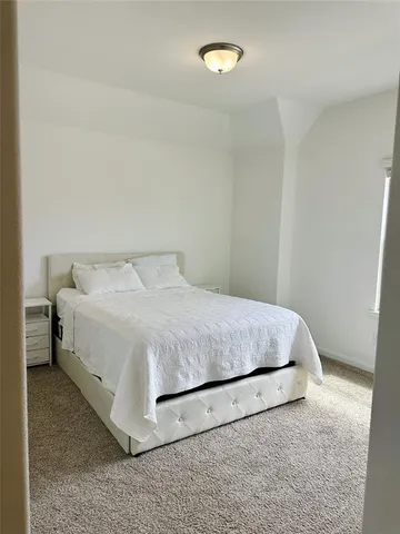 a bedroom with a bed and a table