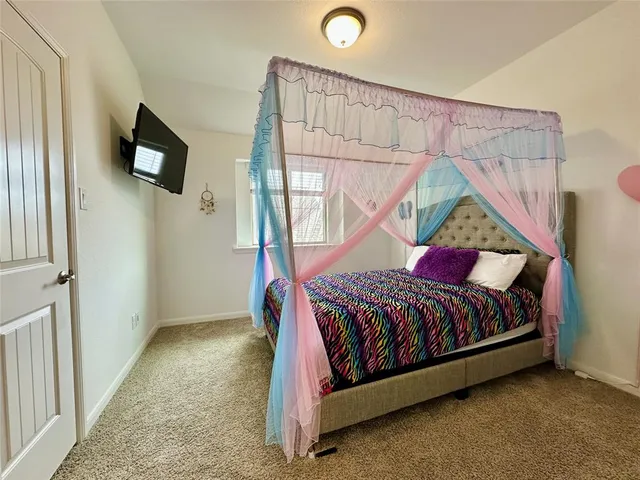 a bed sitting in a bedroom next to a small yard