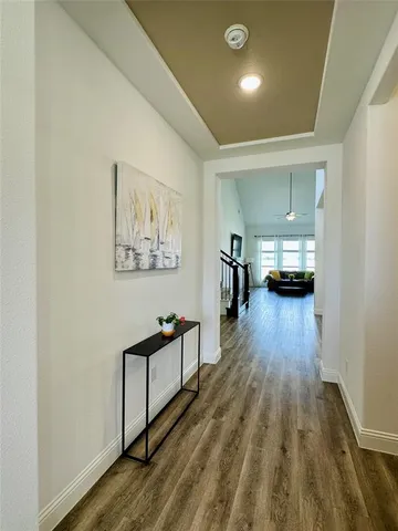 a view of a hallway view with wooden floor and furniture