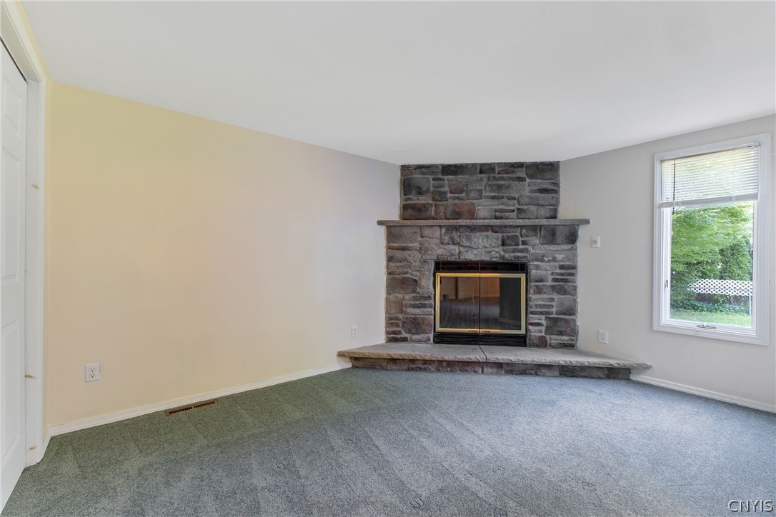 125 Circle Road Salina, NY 13212 - Photo 22 of 39 Primary bedroom with seating area, wood fireplace, double closets, & full bath.