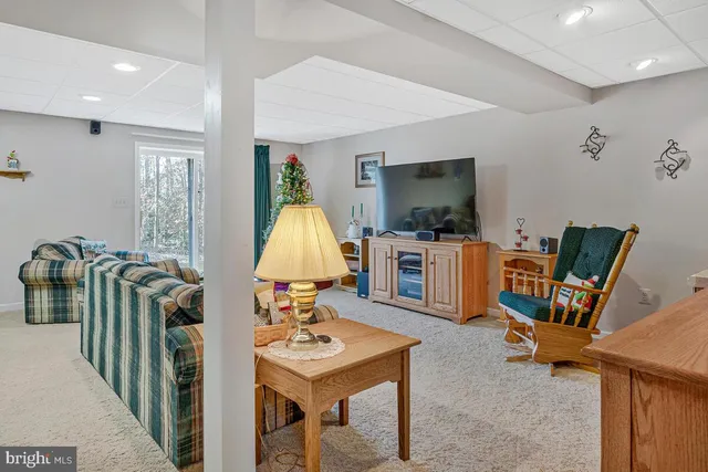 a view of a workspace with furniture and a flat screen tv