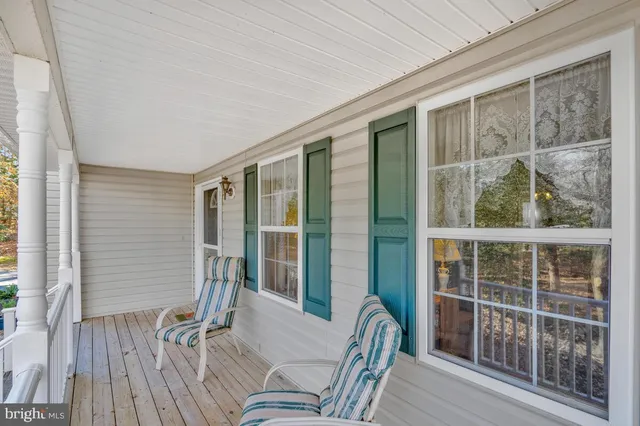a balcony with furniture and wooden floor
