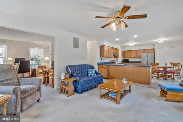a living room with furniture and kitchen view