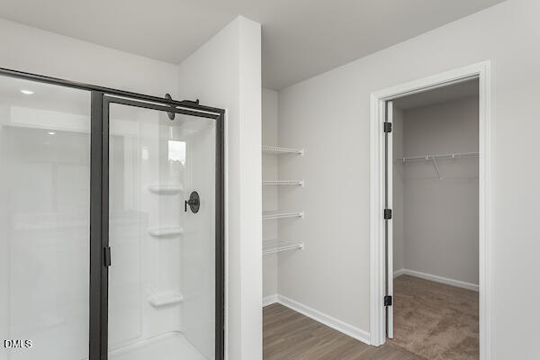 64 Rider Street Broadway, NC 27505 - Photo 9 of 11 a bathroom with a glass shower door